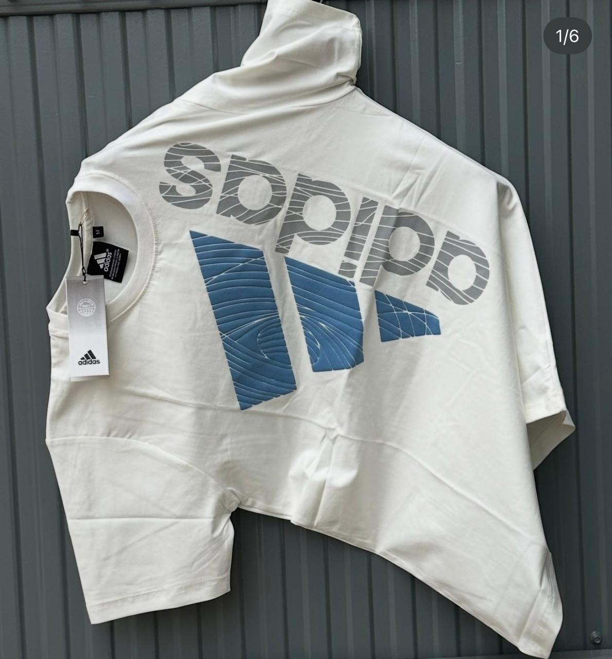 White sleeveless jacket with Adidas logo on a gray background