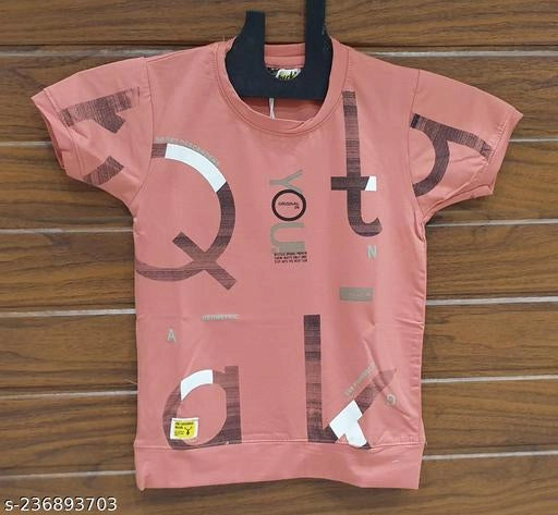 Pink t-shirt with text design on a wooden surface