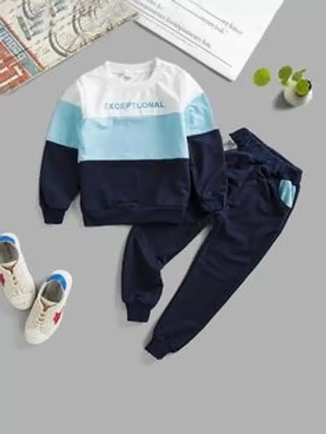 Children's two-piece outfit with a color-blocked sweatshirt and pants on a gray surface.